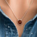 The 18" sterling silver Baltic amber necklace worn over a denim shirt on a model showcasing its quirky charm.
